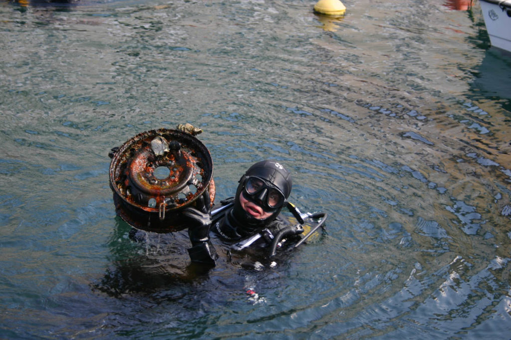 Marco Russo solleva il suo trofeo durante la pulizia del Canal Grande di Trieste - 2013